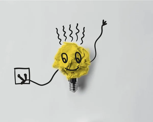 Top View Crumpled Paper Light Bulb Smile Plug Electricity Concept — стоковое фото